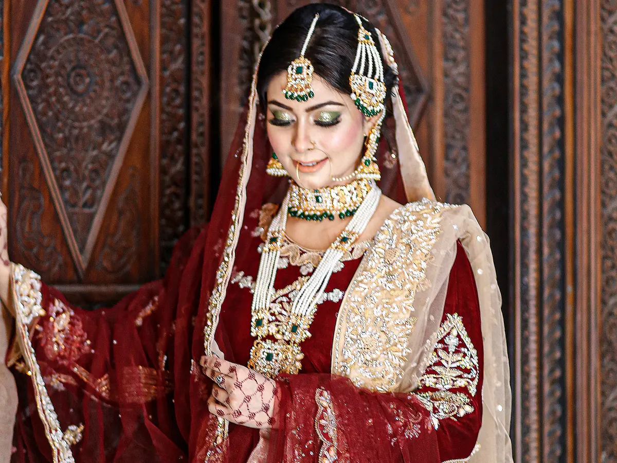 Traditional red bridal makeup and styling by Morning Glory Beauty Clinic in Jhelum