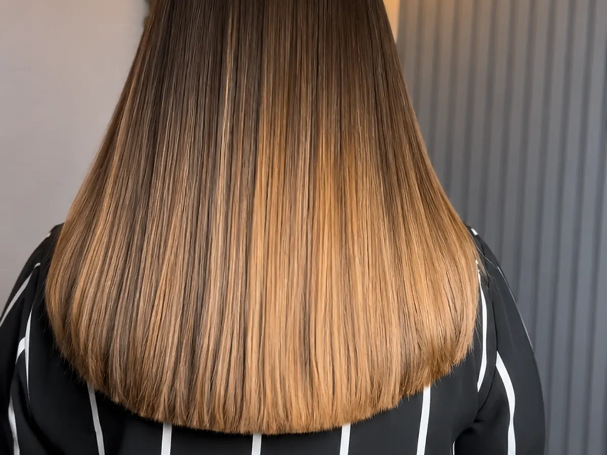 Back view of smooth brown and blonde hair colour at Morning Glory Beauty Clinic in Jhelum.