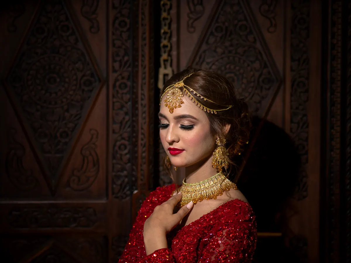 Evening makeup with gold eye makeup, red lipstick and an updo at Morning Glory in Jhelum